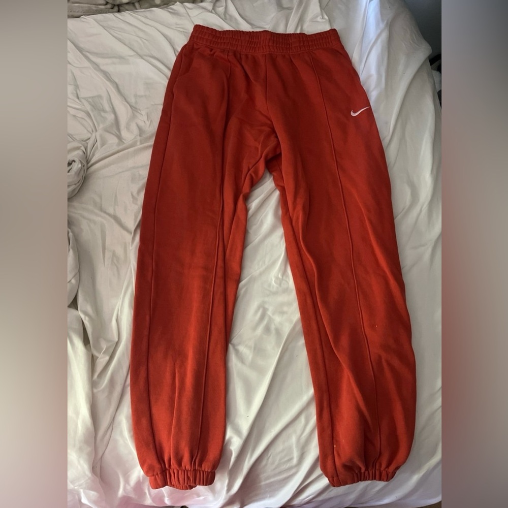 Orange Nike sweatpants, size women’s M